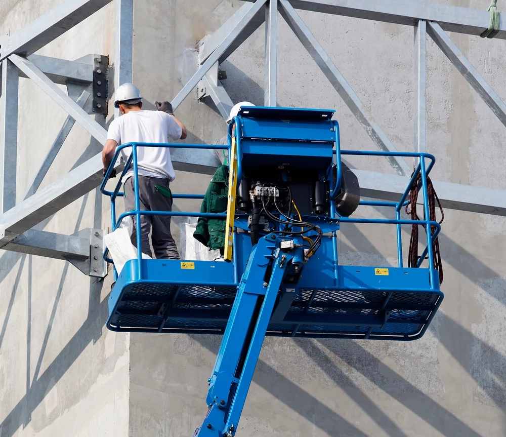 Boom Lift lifting construction worker at a Downtown Beaumont, Texas building site