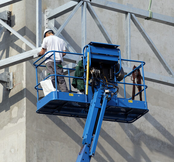 Boom lift used for elevated exterior construction work in Irving, TX