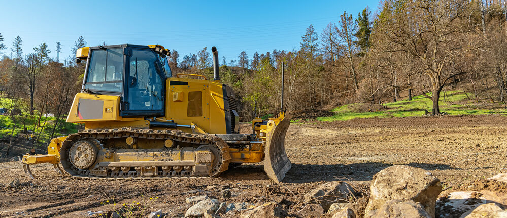 Bulldozer clearing land at a residential construction site in Tomball, TX