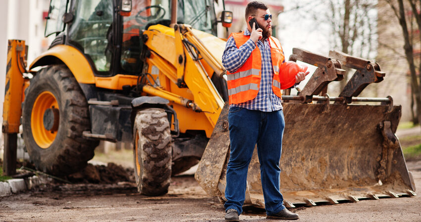 Construction worker operating an excavator on a construction site in Austin, TX