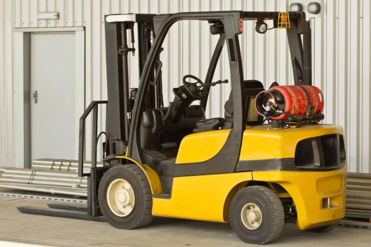 A forklift is parked in front of a building.