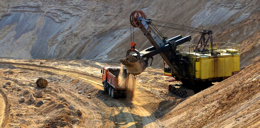 Excavator digging at a dry, desert construction site in El Paso, Texas