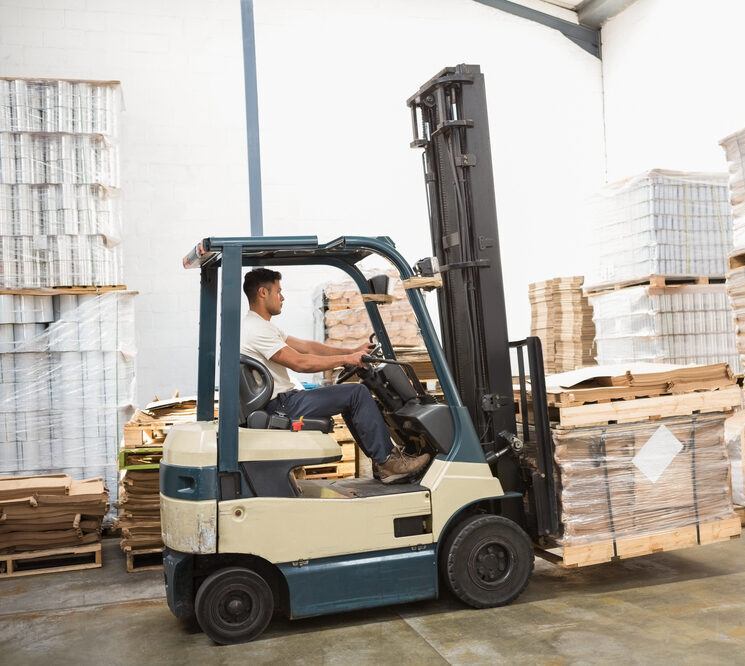 Forklift transporting construction materials at a busy job site in Arlington, TX