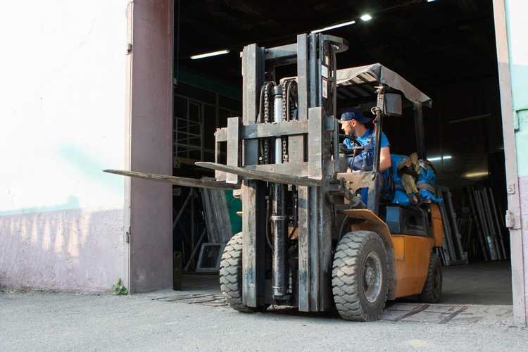 Forklift handling materials at an active New Braunfels job site