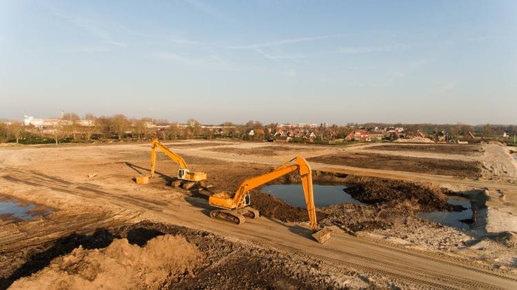 Heavy construction equipment working on commercial development site in Milpitas, California