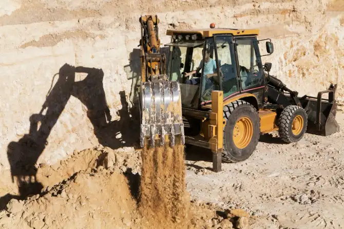 Heavy duty excavator of National Dispatching working in daylight.