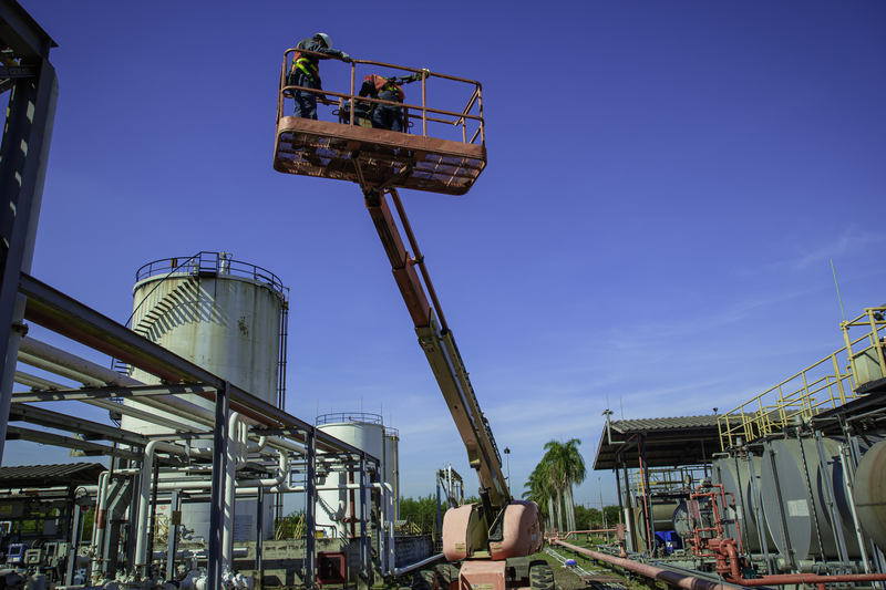 Telescopic boom lift used for facade work on a multi-story building in Conroe, Texas