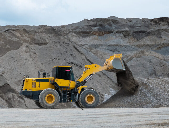 Heavy construction wheel loader moving gravel at a quarry in Commerce City, CO