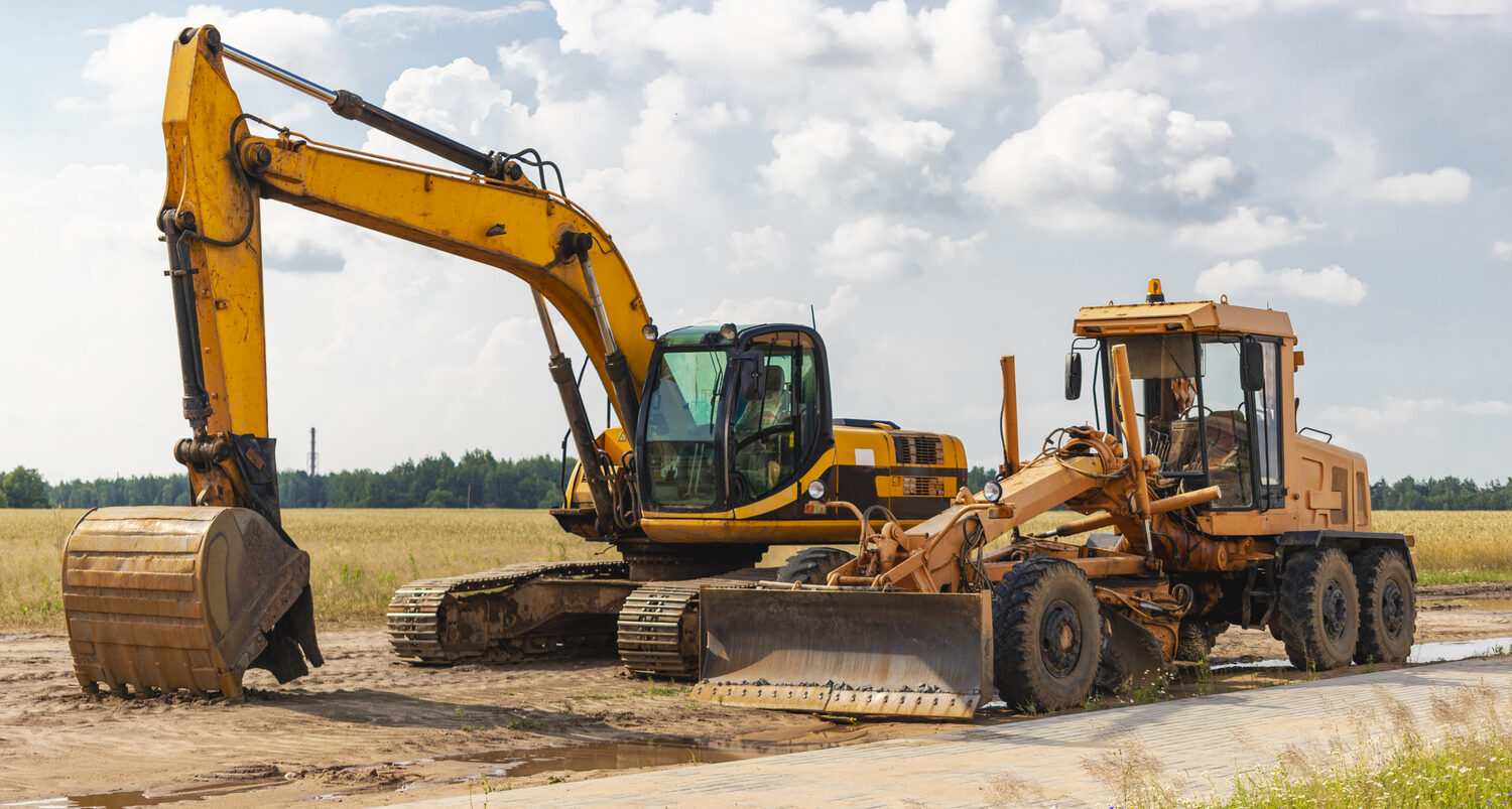 The excavator and the grader in a construction site. Heavy construction equipment rental in Paramount, CA
