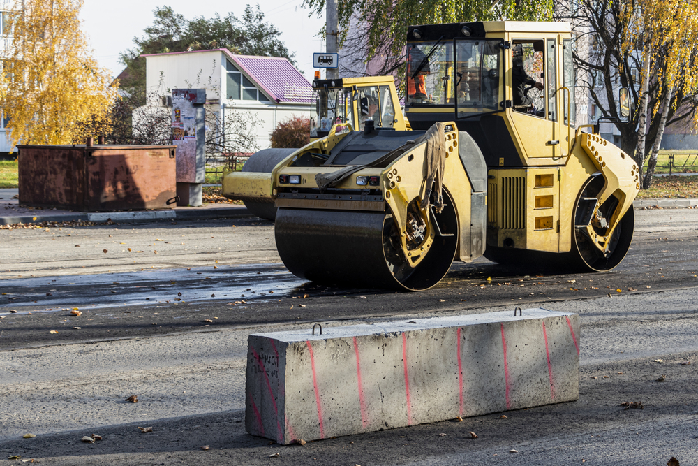 Asphalt compactor roller working on a road construction site in Channahon, IL
