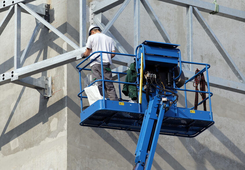 Scissor lift being used for multi-storey building works in Panama City, FL.
