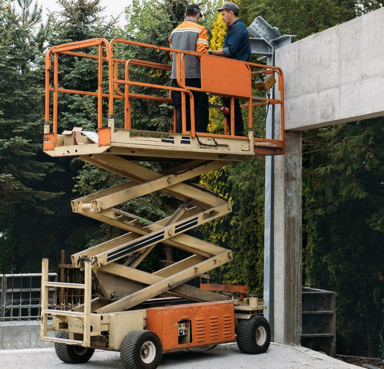 Scissor lift in use during residential framing work in Humble, Texas