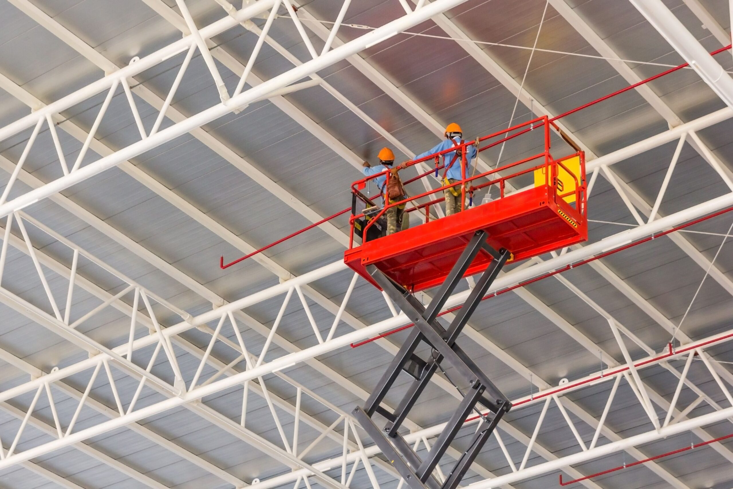 Aerial construction work using scissor lift in Houston, Texas