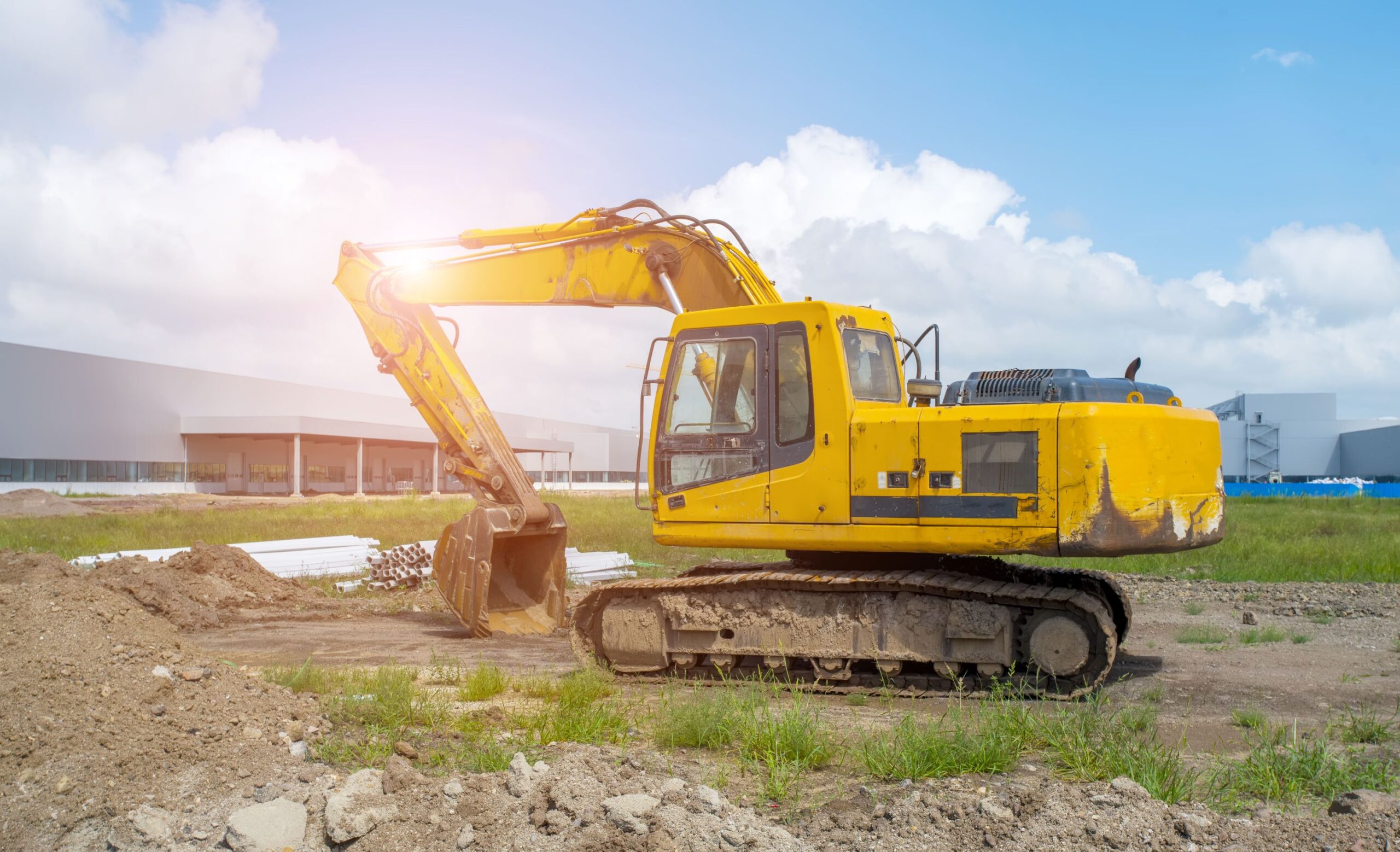 Yellow excavator operating on a construction site in Houston, TX