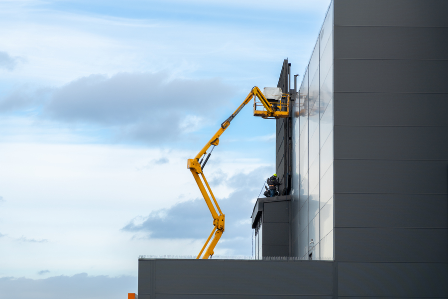 Boom lift in use on the side of a high-rise building in Dallas, Texas