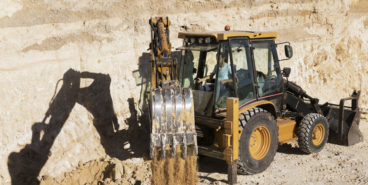 Backhoe loader moving earth