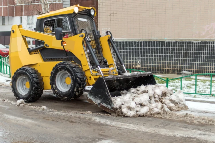skid steers in California removing snow from roads