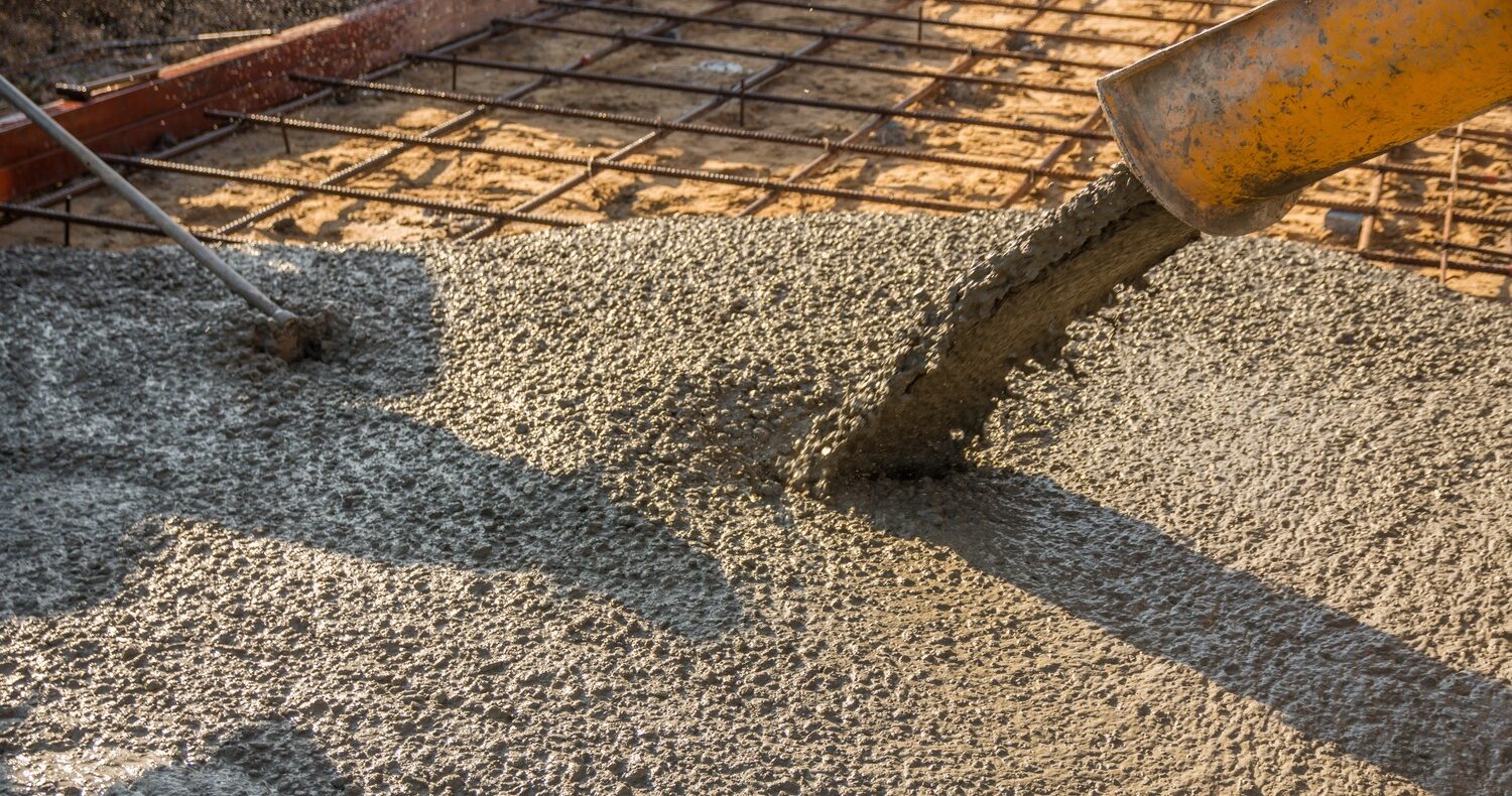 Freshly poured concrete slab in a residential setting.