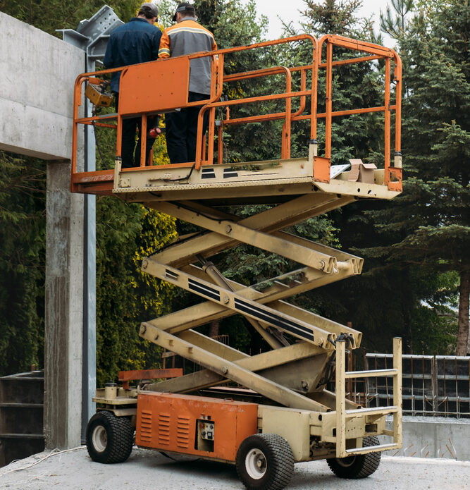 Scissor lift being used on a commercial development project in Orlando, Florida