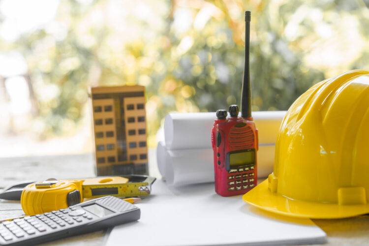 Construction planning tools on a desk, representing early preparation for peak rental seasons like summer in USA
