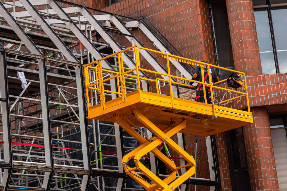 Scissor lift operating in construction site