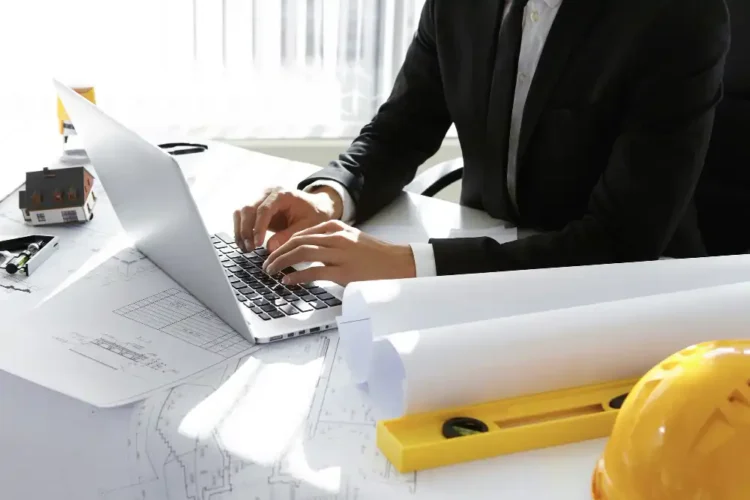 Construction professional working on a laptop